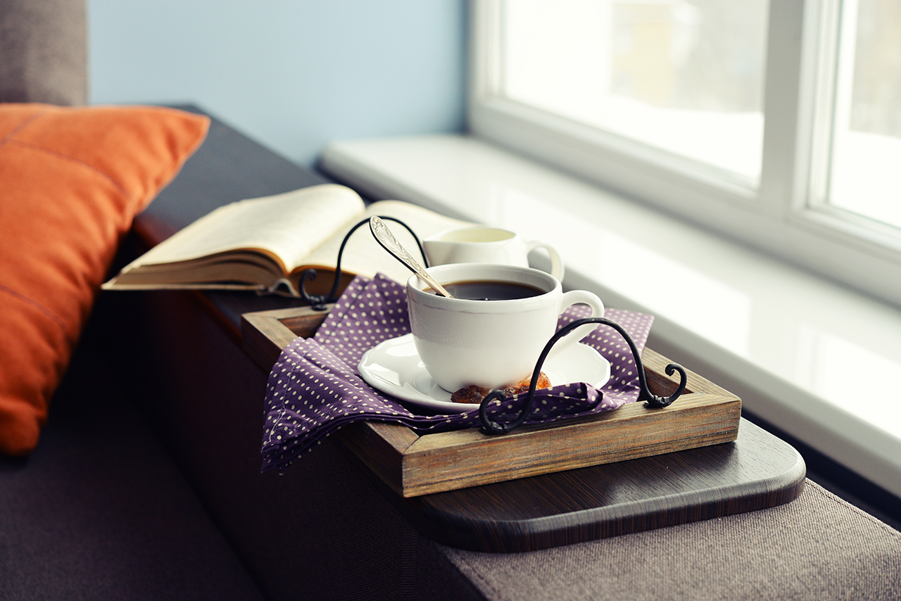 Cup of coffee on vintage tray AT VILLAGE MANOR APARTMENT